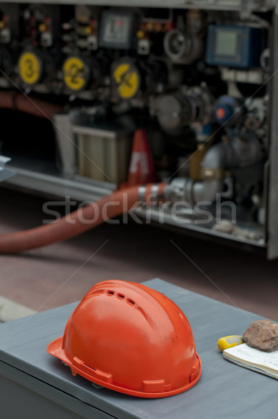 Fuel truck and red helmet close up