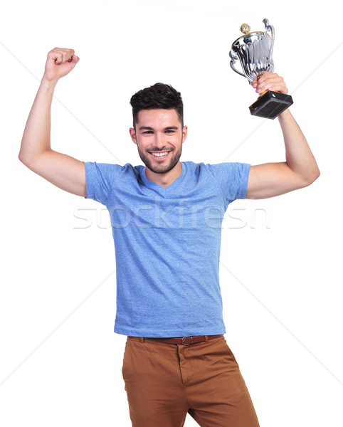 stock photo: winning young casual man with a big trophy cup and