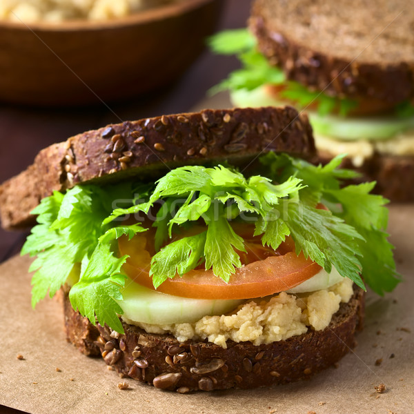 vegan wholegrain sandwich with celery leaves, tomato, cucumber