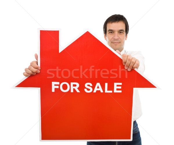 confident salesman with house for sale sign stock photo 08