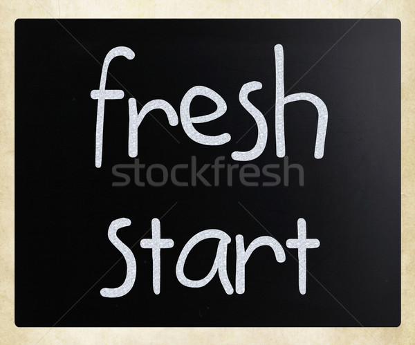 "fresh start handwritten with white chalk on blackboard