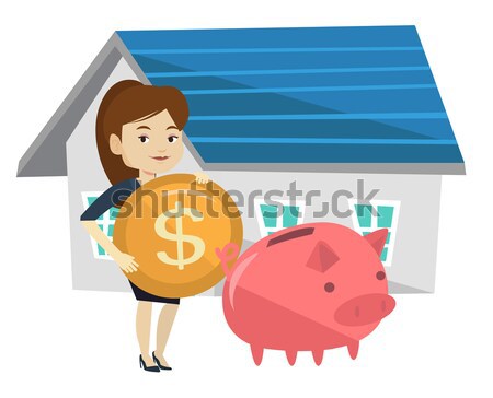 stock photo: woman puts money into piggy bank for buying house.