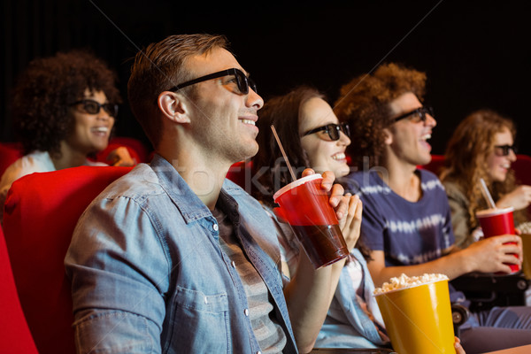 stock photo: young friends watching a 3d film at the cinema