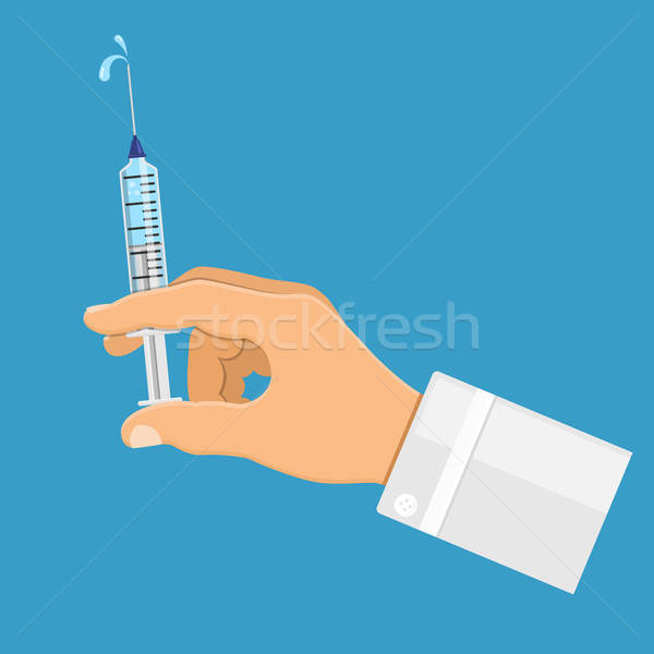 Doctor holding syringe in hand Stock photo © -TAlex-