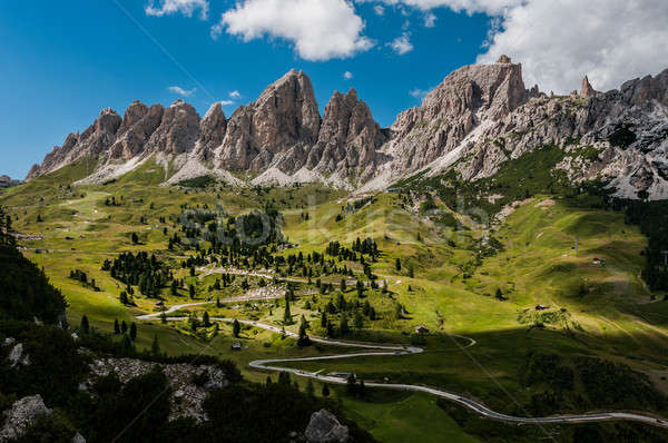 Stock photo: Road with many turns leading thru the mountain massifs.