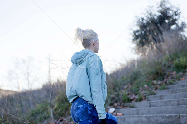 Active cheerful blonde pausing after a run in a park on a sunny  Stock photo © 2Design