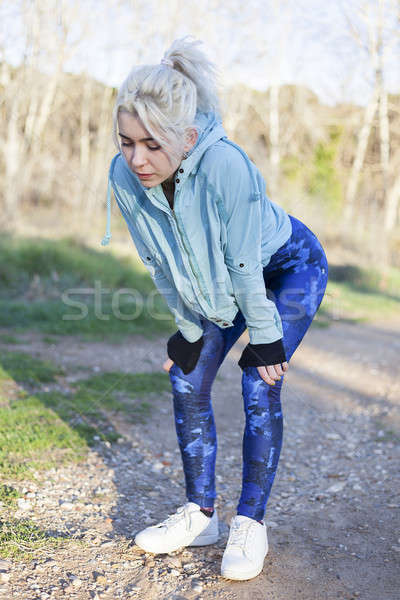Active cheerful blonde pausing after a run in a park on a sunny  Stock photo © 2Design