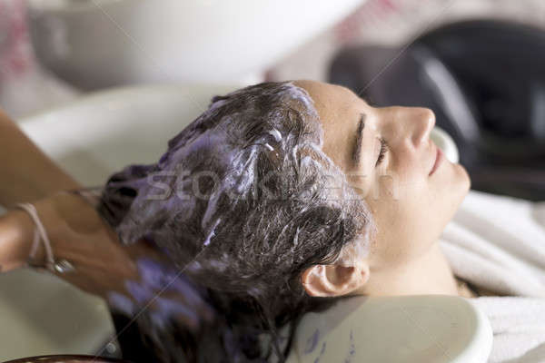 Young woman washing hair in salon Stock photo © 2Design