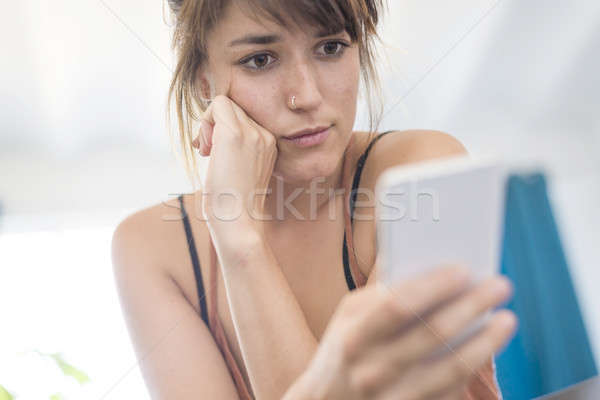 Portrait of happy young businesswoman using mobile phone in offi Stock photo © 2Design