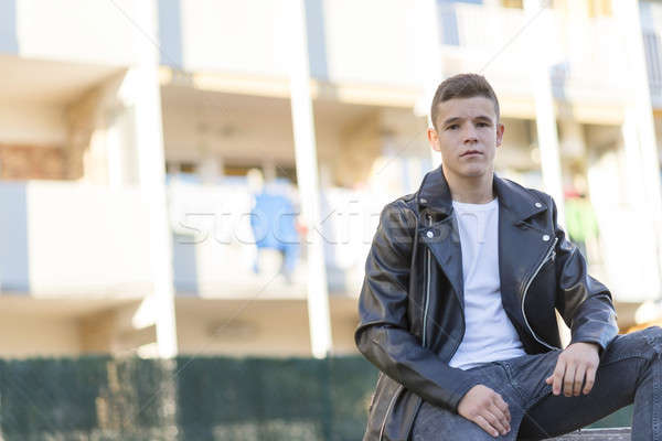 Stylish young man in leather jacket looking at camera, sitting i Stock photo © 2Design