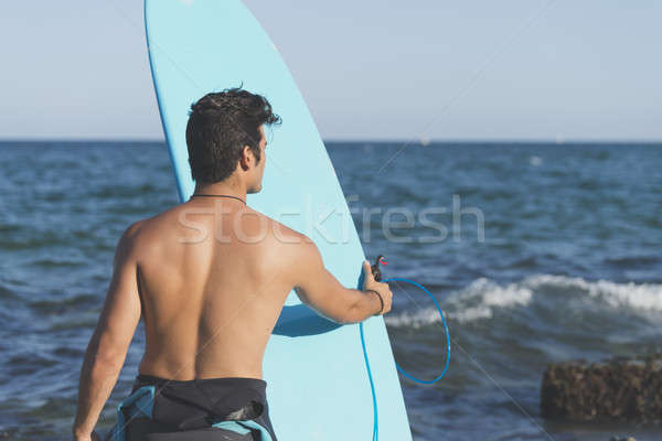 Surfer holding his blue surfboard Stock photo © 2Design
