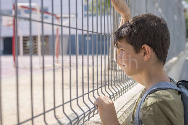 Cheerful child carrying his backpack standing in front of the sc Stock photo © 2Design
