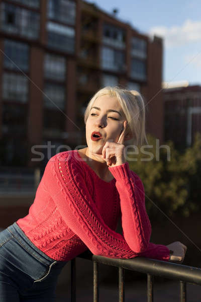 Portrait of a young blonde woman gesturing in the street Stock photo © 2Design
