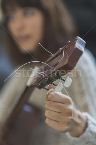 Belo mulher jovem sessão sofá jogar guitarra Foto stock © 2Design