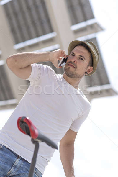 Portrait of a happy businessman walking outdoors with mobile pho Stock photo © 2Design