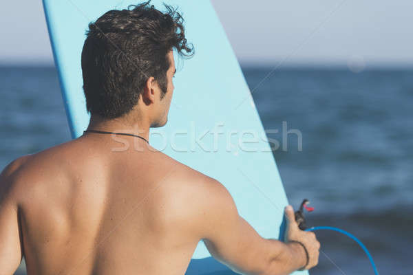 Surfer holding his blue surfboard Stock photo © 2Design