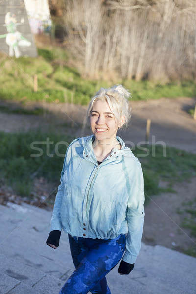 Active cheerful blonde pausing after a run in a park on a sunny  Stock photo © 2Design