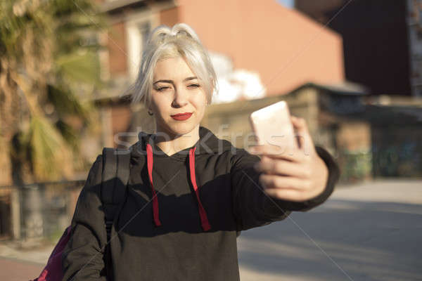 young beautiful woman sitting and taking a picture with mobile p Stock photo © 2Design