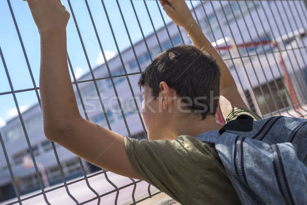 Cheerful child carrying his backpack standing in front of the sc Stock photo © 2Design