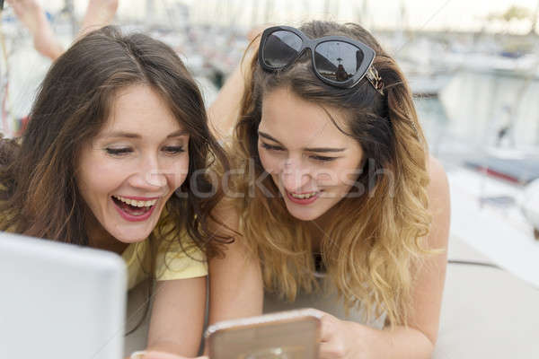 Happy joyful female friends enjoying talks and having fun online Stock photo © 2Design