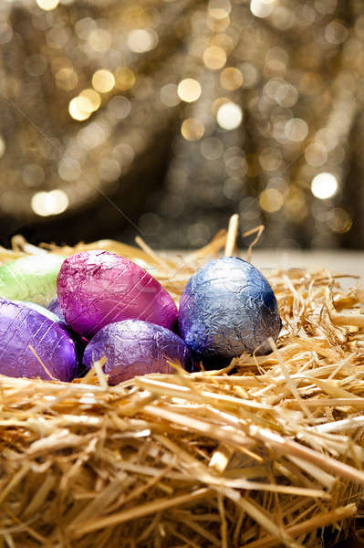 Chocolate Easter eggs in a natural straw nest Stock photo © 3523studio