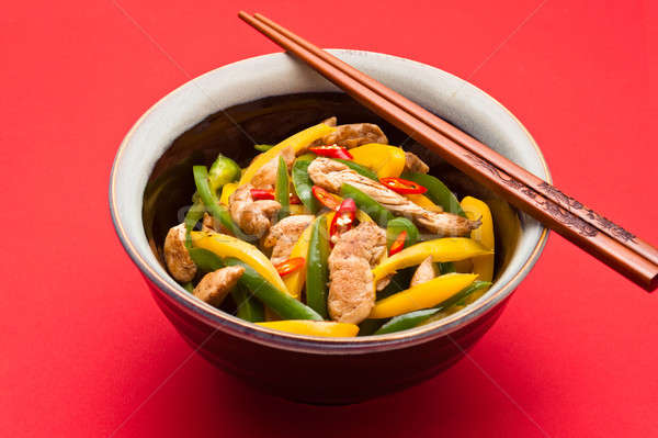 Stock photo: Fried Chicken with capsicum on red table cloth