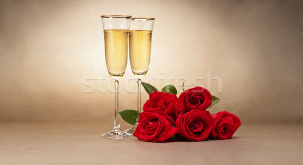 Stock photo: Champagne glasses and roses 