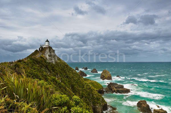 Nugget Point Light House and dark clouds in the sky Stock photo © 3523studio