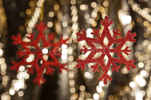 Red snow flake on a gold glitter background Stock photo © 3523studio