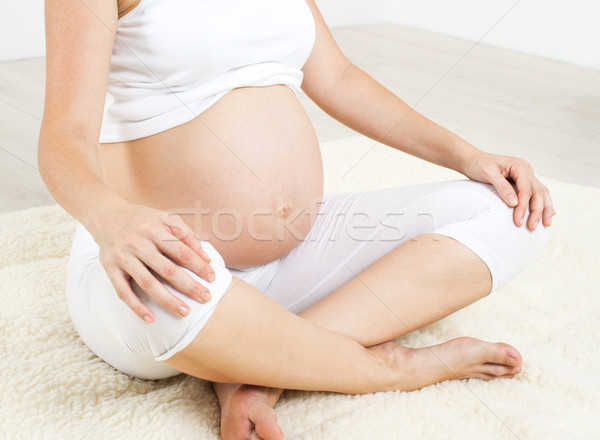 Beautiful pregnant woman relaxing in living room  Stock photo © 3dvin