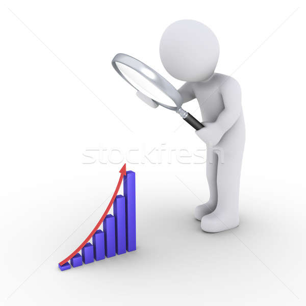Stock photo: Person with magnifier looking for good results graph