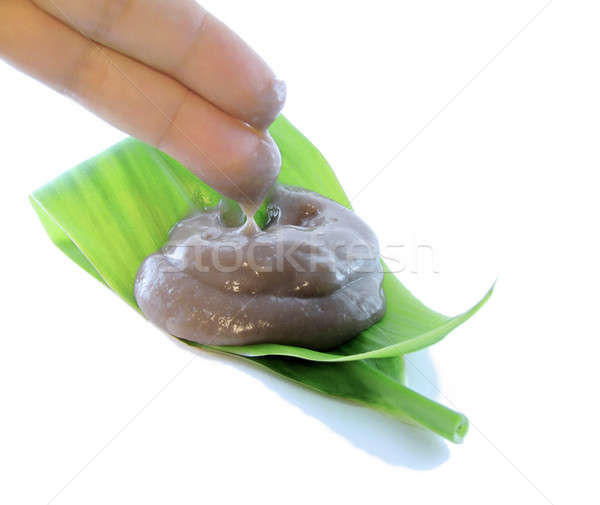 Poi being scooped by two fingers on a tea leaf Stock photo © 808isgreat