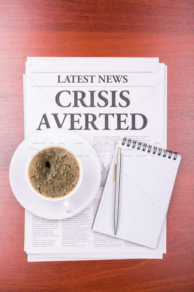 Stock photo: The newspaper CRISIS AVERTED  and coffee