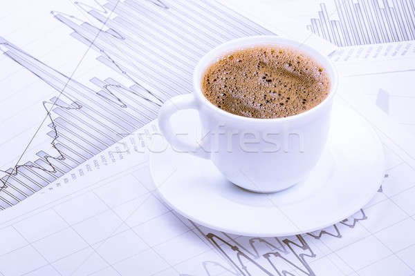 Stock photo: Cup of coffee and graphs