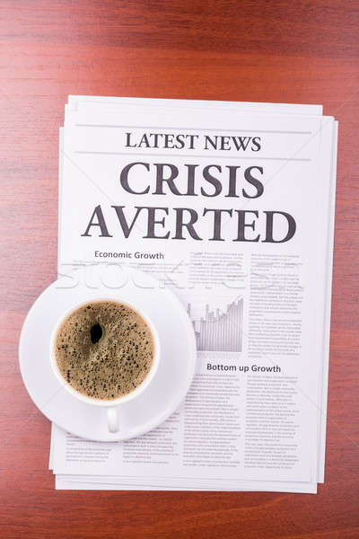 Stock photo: The newspaper CRISIS AVERTED  and coffee