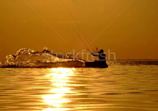 Silhouette of a kitesurf on a gulf on a sunset Stock photo © acidgrey