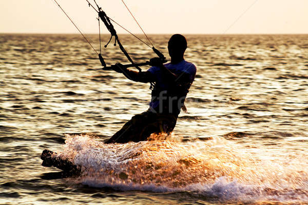 Silhouette of a kitesurfer on a waves Stock photo © acidgrey