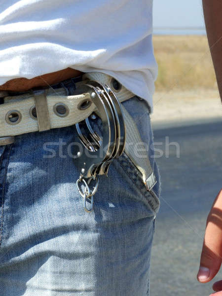 The handcuffs hanging on a belt of jeans Stock photo © acidgrey