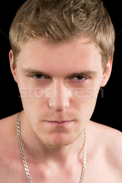 Verdächtige junger Mann Porträt isoliert schwarz Stock foto © acidgrey