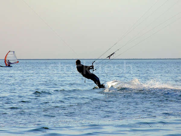 Silhouette of a kite-surf on waves of a gulf 1 Stock photo © acidgrey