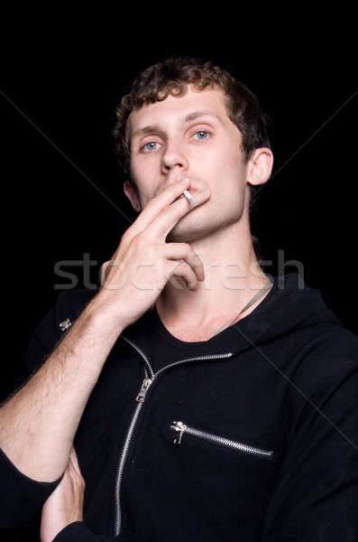 молодым человеком сигарету изолированный черный лице дым Сток-фото © acidgrey
