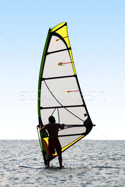Silhouette of a windsurfer on waves of a sea  Stock photo © acidgrey