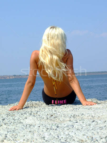 The girl-blonde sits on coast of a gulf Stock photo © acidgrey