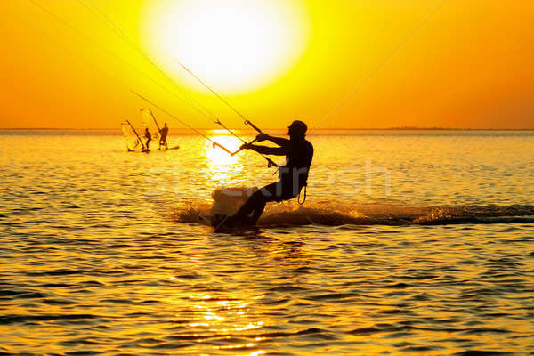 Silhuetas navegação pôr do sol céu água Foto stock © acidgrey
