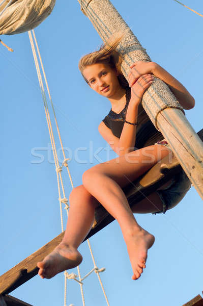 Teen girl hugging the mast Stock photo © acidgrey