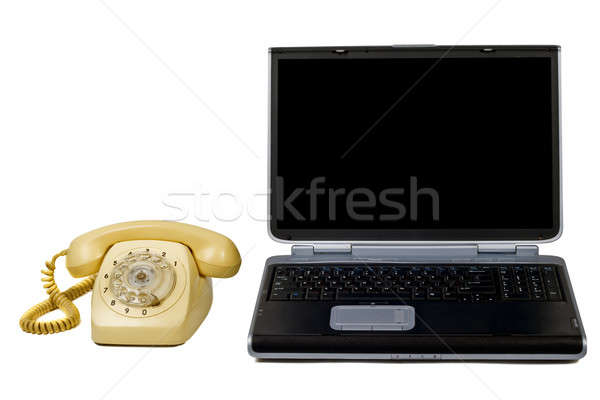 Stock photo: Laptop and old phone. Isolated on white