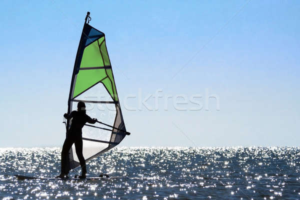 Silhouette of a woman windsurfer Stock photo © acidgrey