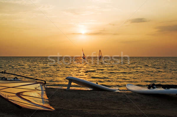 Silhouette of a two windsurfer on a gulf on a sunset Stock photo © acidgrey