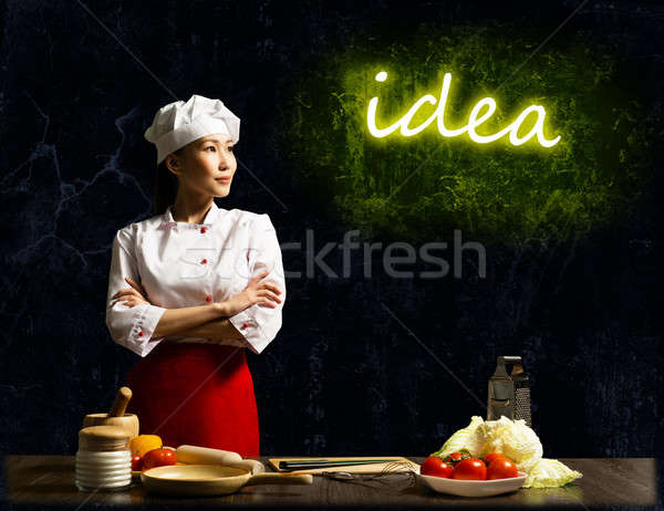 Asian female chef looking at the glowing idea Stock photo © adam121