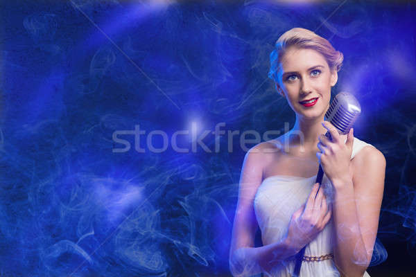 attractive female singer with microphone Stock photo © adam121